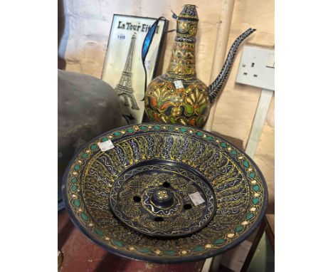 A 20th Century Middle Eastern tin pitcher and bowl with enamel decoration on a blue painted ground