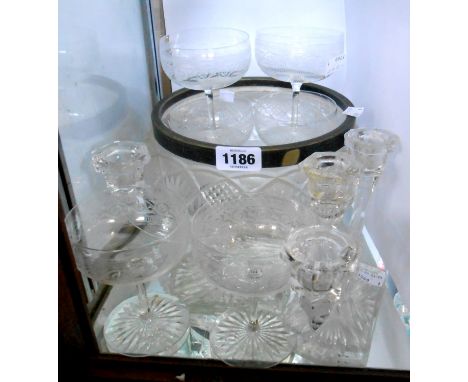 A quantity of glassware comprising a set of six Edwardian acid etched champagne coupes, a pair of press moulded candelabra an