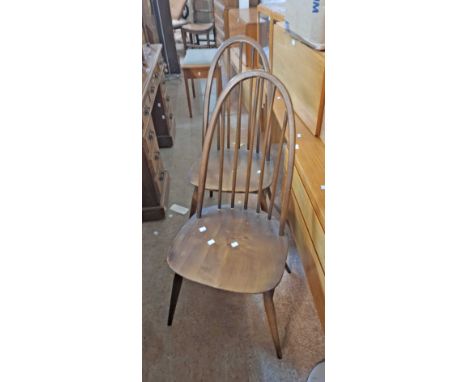 A pair of Ercol dark elm hoop stick back dining chairs