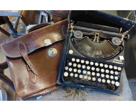 A cased Smith Premier typewriter - sold with an old satchel