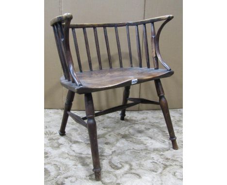 A Windsor stick back chair of rustic form with ashwood seat on turned supports 