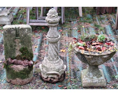 An unusual weathered natural stone block, with applied cast iron cherub, 56cm high, together with a reclaimed garden urn of c