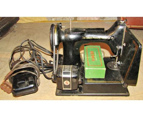 A vintage Singer electric powered sewing machine with combined light and pedal controller to include ?the crescendo junior so