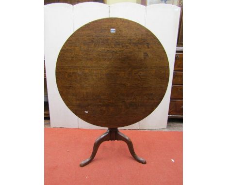 A Georgian oak snap top table, the circular top 90 cm in diameter, set on a turned pillar and tripod base 