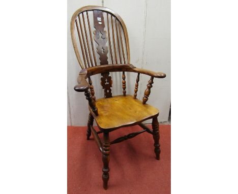 A good Georgian Windsor comb back elbow chair principally in elm and  yew wood with shaped and pierced splat 