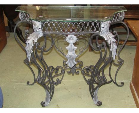 A contemporary ironwork occasional table of the Rococo style with repeating detail and set beneath a plate glass top, 90 cm w