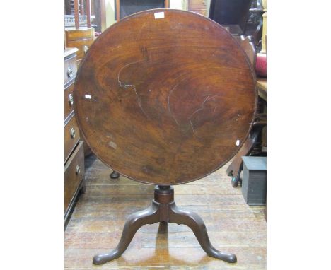 A Georgian mahogany snap top table, the circular one piece top 81cm diameter, raised on a vase shaped pillar and tripod base 