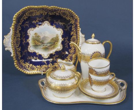 A continental coffee for two set with blue and gilt decoration on a white ground comprising coffee pot, covered sucrier, milk