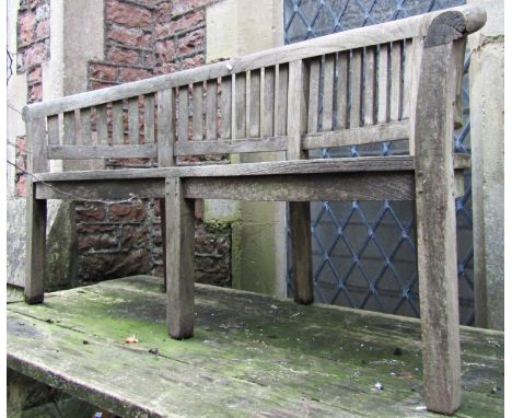 A weathered teak wood banana shaped bench, 160cm long (af) 