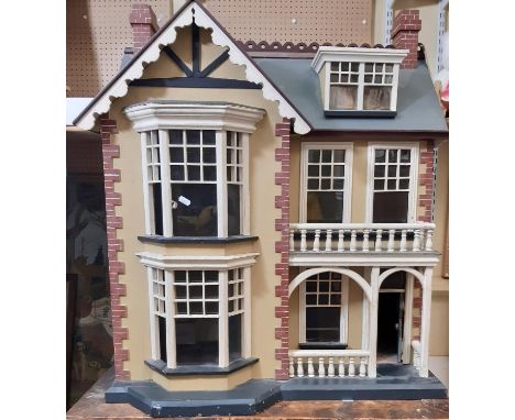Impressive vintage wooden dolls house in the style of a Victorian town house  with painted finish, arched entrance, bay windo