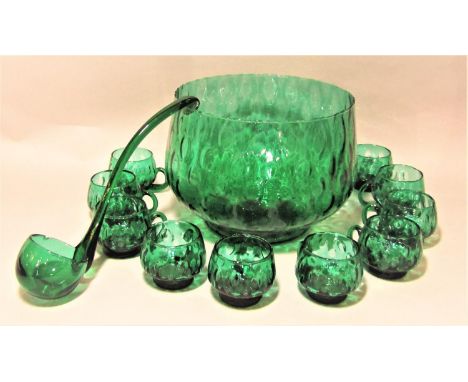 Italian green glass punch bowl ladle and eight cups with geometric bubble decoration, the punch bowl 21cm high x 26cm diamete