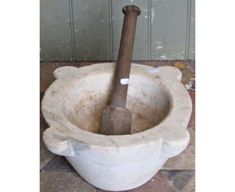 A vintage white marble mortar with wooden pestle, 37cm diameter 