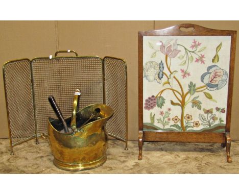 A collection of hearth side effects including a folding firescreen within a polished brass frame, a bras coal bucket, tongs, 