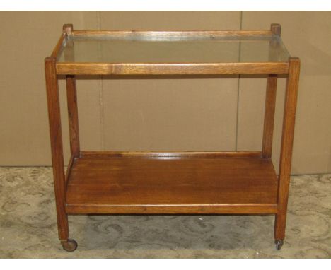 A vintage oak two tier trolley/side table with plate glass top 