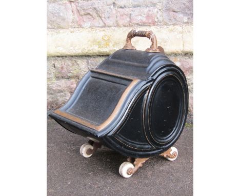A Victorian tole ware coal scuttle with shaped lid ,cast fittings and ceramic castors 