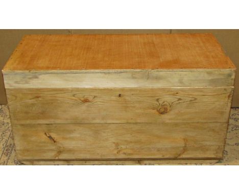 A vintage stripped pine box with iron work drop carrying handles, exposed dove tail construction beneath a hinged lid with pl