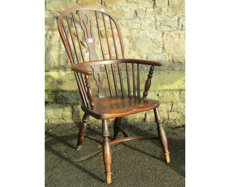 A 19th century windsor mixed wood hoop and stick back elbow chair with pierced splat turned supports united by a crinoline st