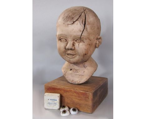 Unusual carved wooden bust sculpture of a babies bust upon an oak plinth, 28cm high, together with three ceramic eye balls (4