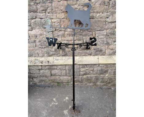 An iron weather vane, the finial pointer in the form of a standing cat, raised on a pole with North, South, East, West 