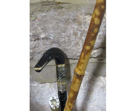 A Victorian bamboo shafted book grabber together with a further novelty riding crop with plaited leather and horseshoe knop a