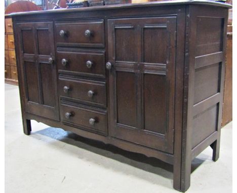 An Ercol sideboard, central tower of four drawers flanked by two cupboards, 150 cm wide 