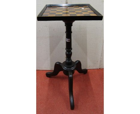 A small games table, the square cut top raised on a turned pillar and tripod base, 32 cm square 