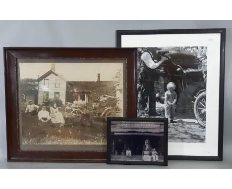 An early 20th century sepia coloured photograph of an American family seated outside their house with a vintage motor car, 40