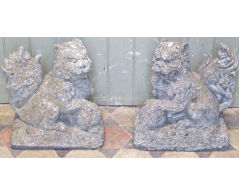 A pair of reclaimed garden ornaments or caps in the form of Chinese Dogs of Fo, with seal marks, 36cm high 