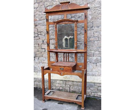 Late 19th century oak hall stand of full height with mirror plate, glove drawer and stickstand, 95 cm wide 