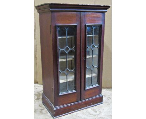 A small Edwardian mahogany table top cabinet enclosed by a pair of leaded light doors, 74cm long x 45cm wide 