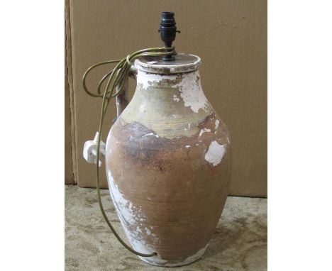 An antique oviform terracotta ewer with simple loop handle and later white washed finish, adapted as a lamp, 43 cm in height 