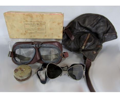 A vintage leather aviation hat and Mk. VIII Anti-Dimming goggles, together with a further set of flying goggles (3) 