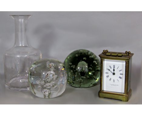 A brass cased carriage clock together with two glass paperweights and a decanter (4) 