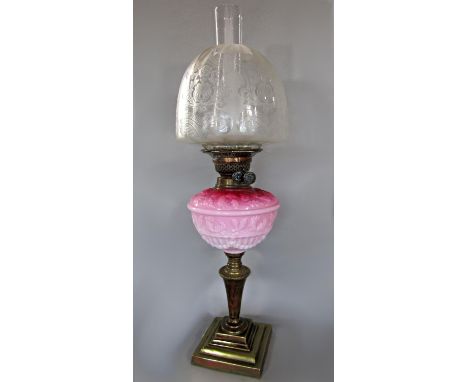 Early 20th century brass and milk glass oil lamp, with tapered beaded column and stepped square base, 64cm high including flu