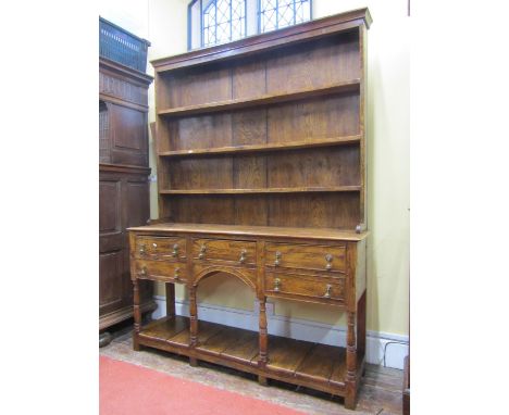A Georgian style cottage dresser in elm, fitted with five drawers over an open pot board with turned column supports, the pla