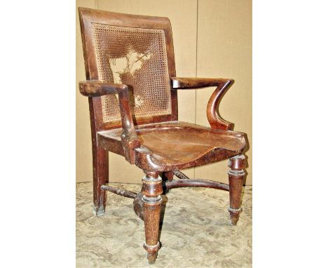 A 19th century mahogany library/desk chair with open arms, deep saddle shaped seat and raised on turned tapered forelegs unit