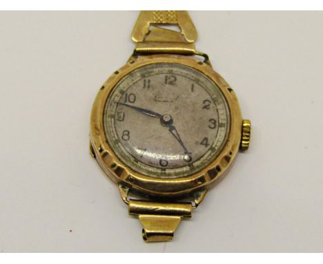 Vintage 9ct Everite dress watch, the textured dial with Arabic numerals upon an associated yellow metal (untested) bracelet, 