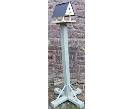 A light green and cream painted rustic wooden bird table and combined nesting box, 174cm high 