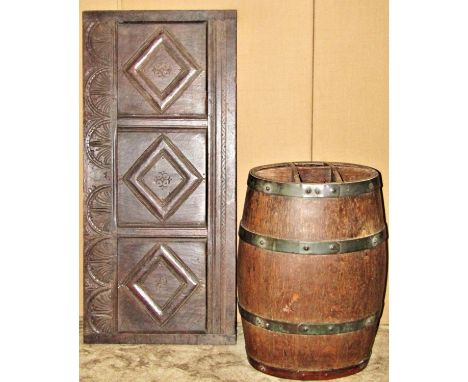 An 18th century oak panel with repeating carved detail, 96cm long, together with a good coopered oak barrel shaped stick stan