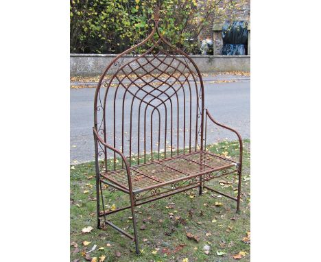 A Regency style light steel framed two seat garden bench, the square tubular frame with scrolled and lattice arched back over