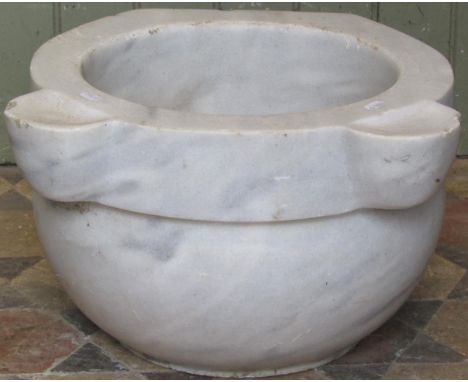 A white marble and grey flecked basin of circular form with slightly dished lugs, approx 50cm diameter at widest point x 28cm