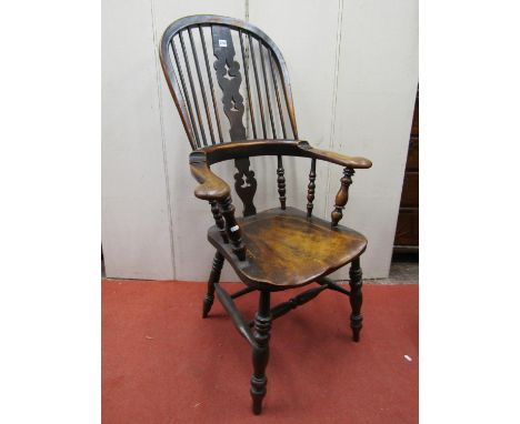 A Georgian Windsor comb back elbow chair principally in elm and fruitwood with carved and pierced splat, turned supports 