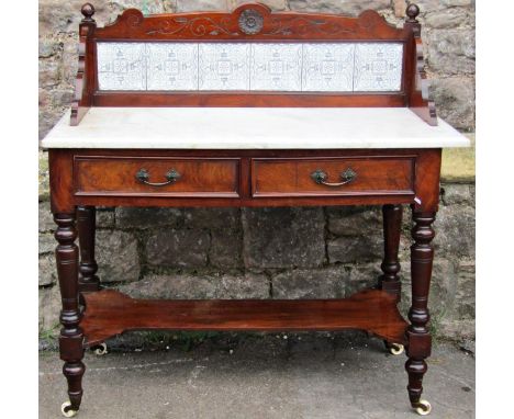 A Victorian walnut washstand raised on turned supports with under gallery and two frieze drawers white marble top supporting 