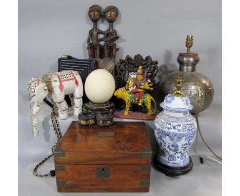 A mixed collection of ethnic and eastern items to include a Rajasthan water vessel converted to a lamp, an elephant puppet, a