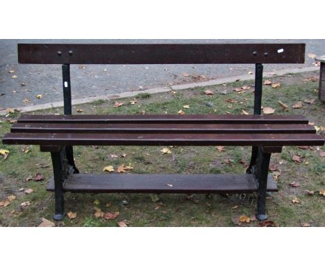 A railway platform bench with timber lathes, raised on cast iron end supports with anthemion detail, 135cm long x 73cm high 