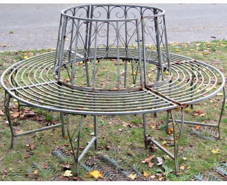 A contemporary sectional light steel framed tree seat, with simple open scroll work detail, 160cm diameter 