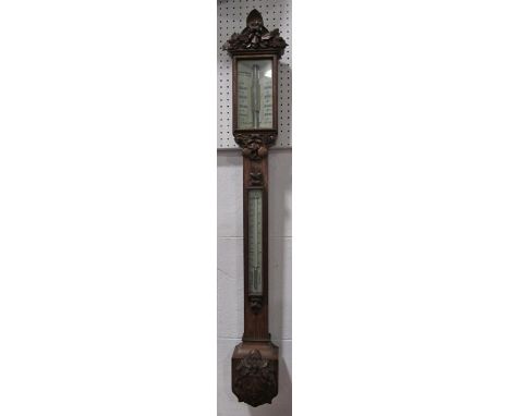 A mid Victorian oak framed stick barometer by Callaghan &amp; Co. of London, 23a New Bond Street. The case work well carved w