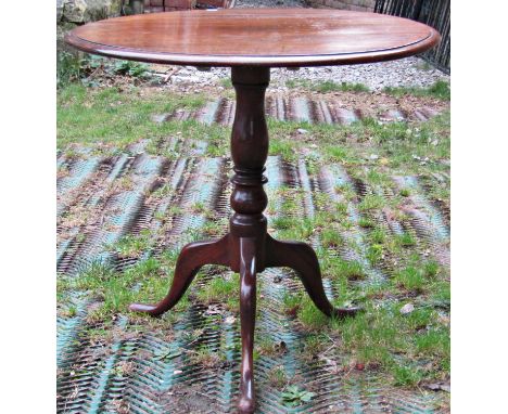 A mahogany snap top table, the circular top 78 cm in diameter, raised on a turned pillar and tripod 