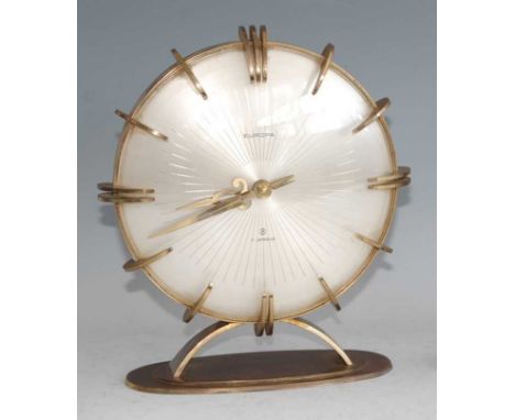 A 1950s gilt brass mantel clock by Europa, the convex circular dial with shaped outer brass bezel markers, with winding movem