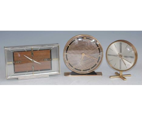 A 1960s Metamec brushed metal and walnut cased mantel clock, the bevelled glass enclosing a rectangular stylised dial, with w